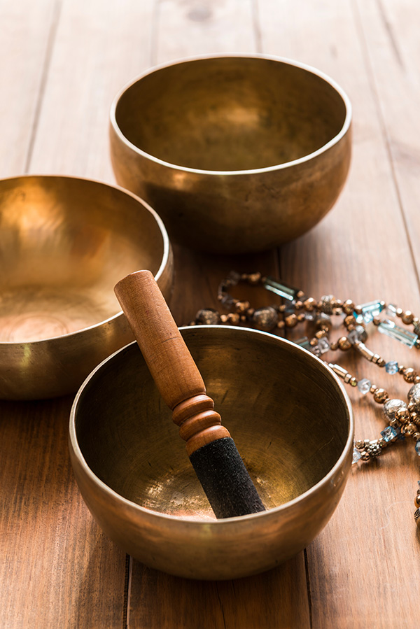 Three metal signing bowls with a mallet.