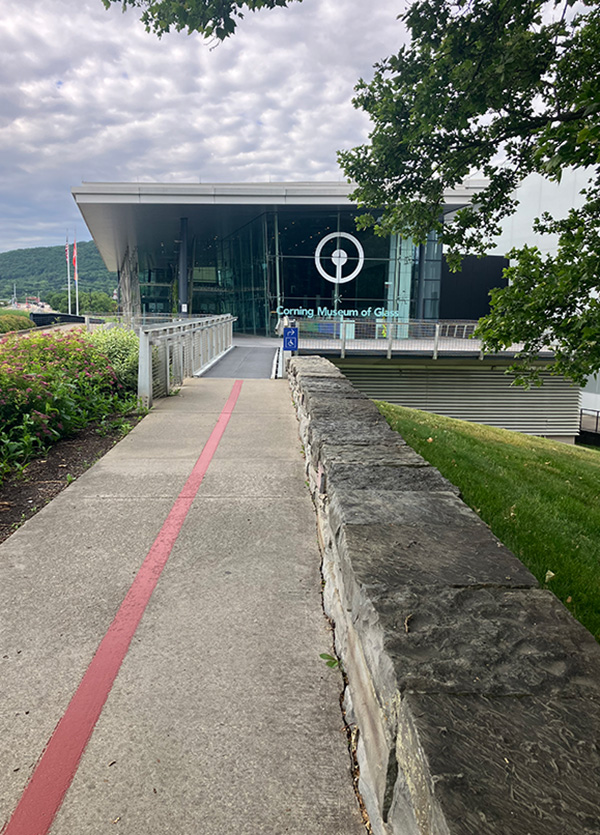 An exterior view of the Corning Museum of Glass in Corning, New York on a cloudy, overcast day.